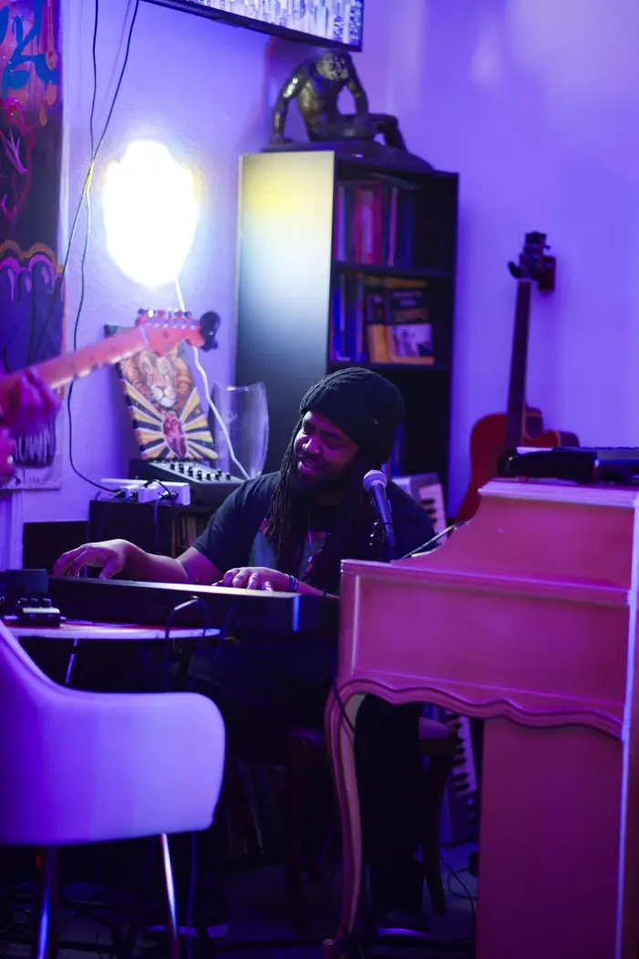 Keys player performing under purple light