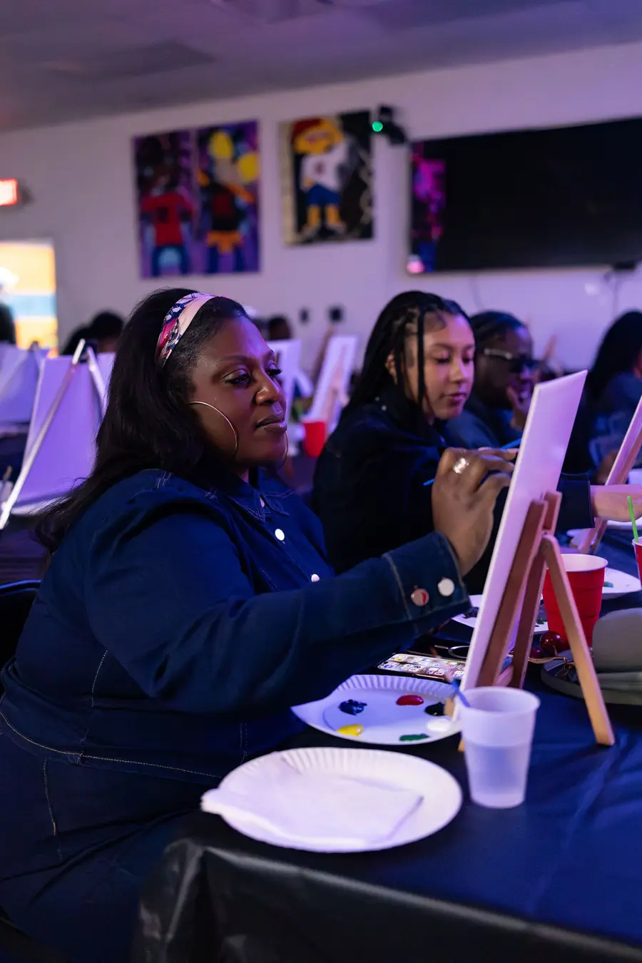 Guests painting together at a Paint & Sip