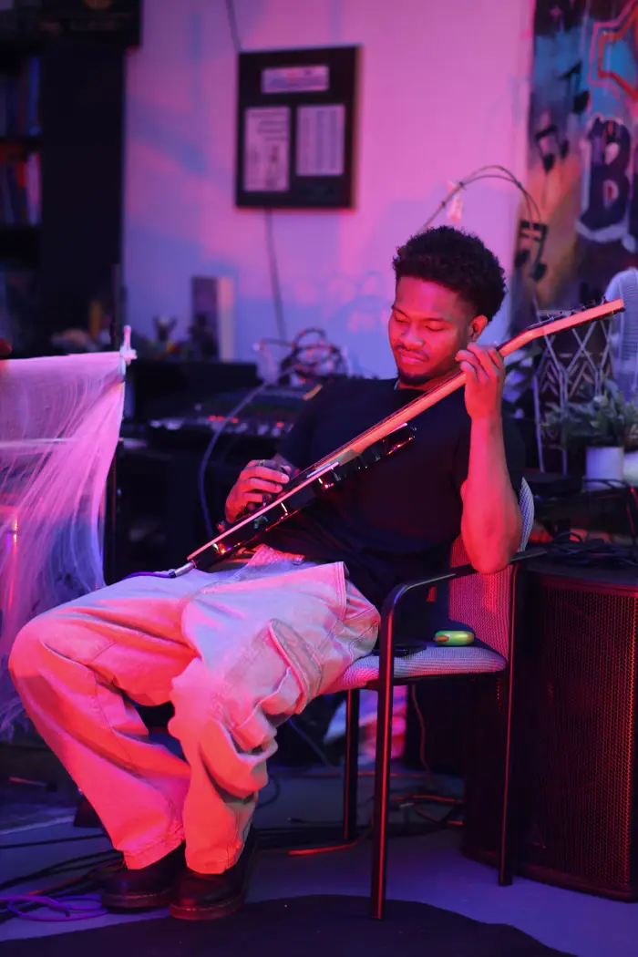 Violinist performing under pink light